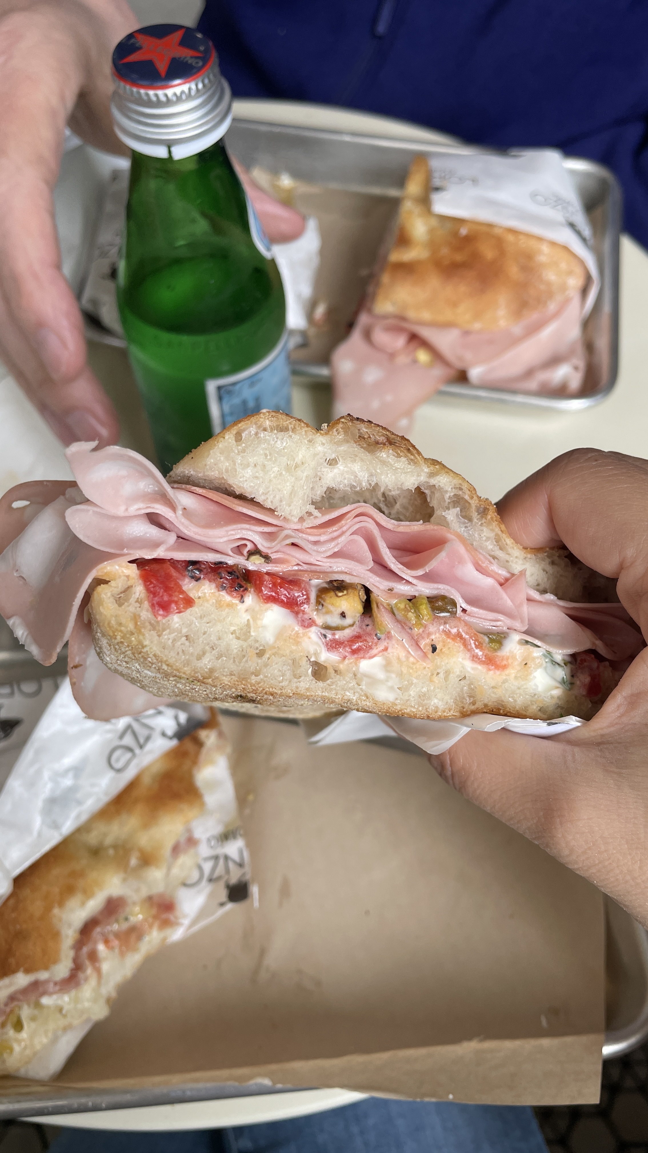 Lorenzo California sandwich cross-section — Mortadella, toasted pistachios, ricotta, roasted peppers on focaccia